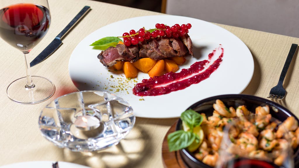 Delicious gourmet steak dinner with wine, served elegantly for fine dining.